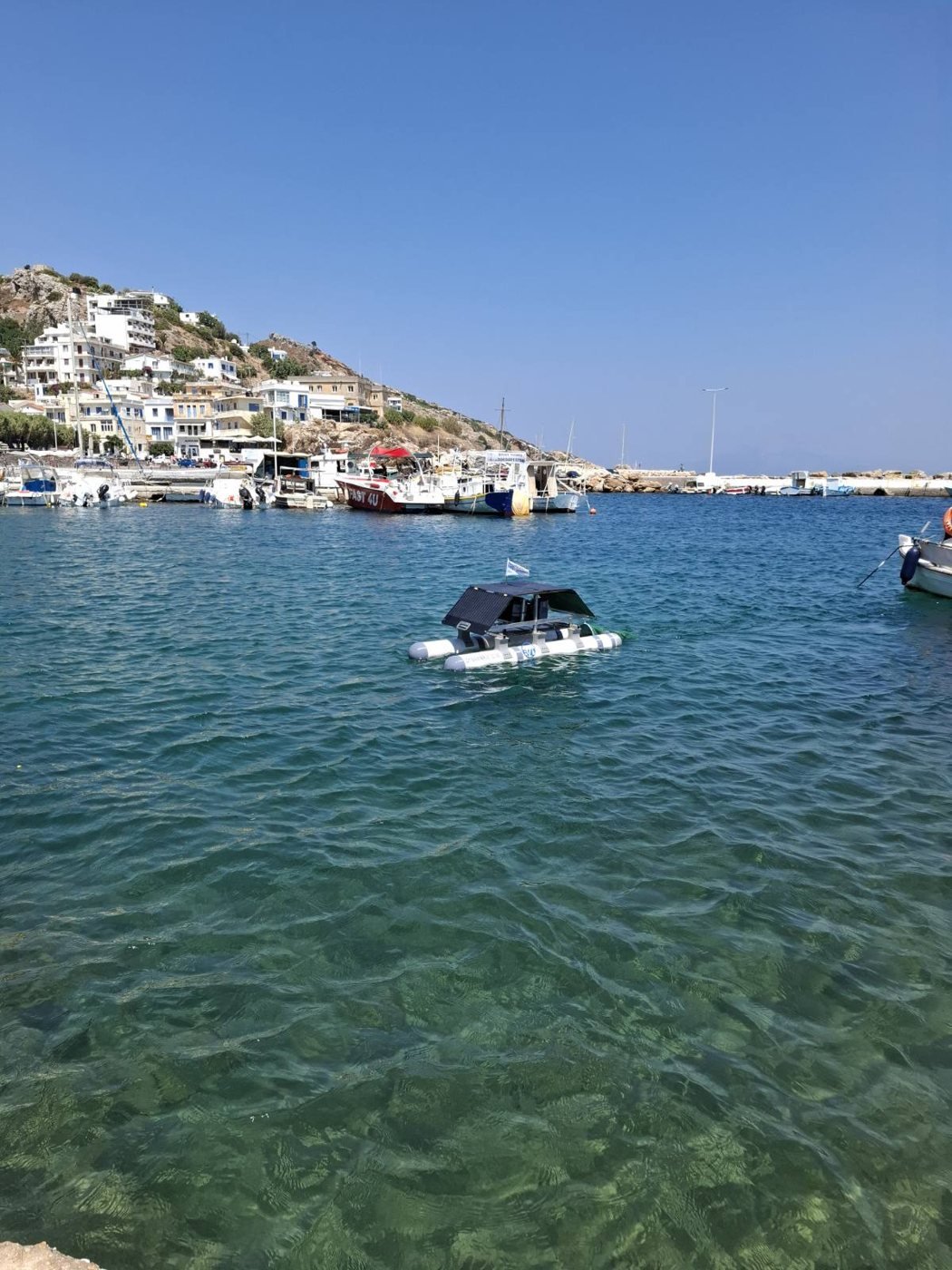 Dynamaris One afloat in the harbour at Agios Kirikos, Ikaria