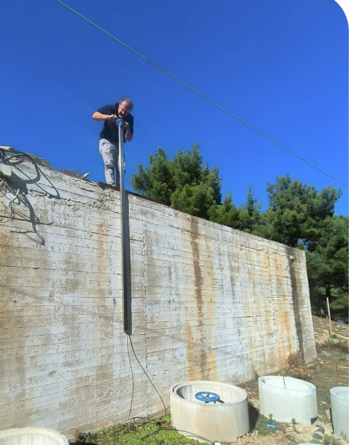 A sensor pole mounted on a flood wall in Ikaria